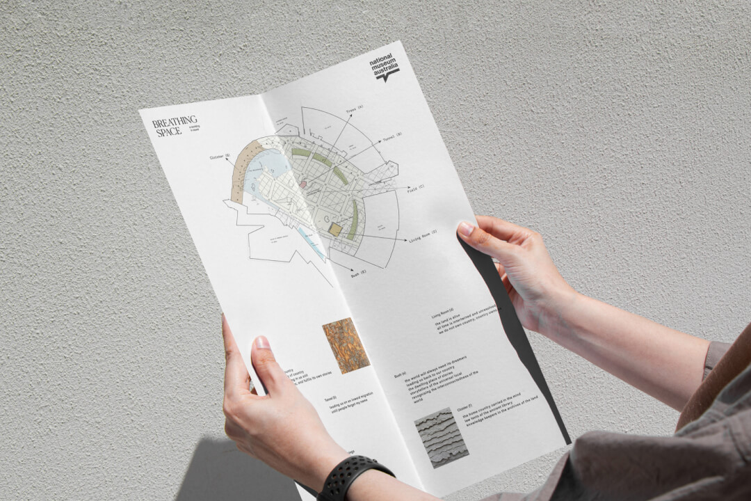 hands holding a map of the breathing space exhibition at the nation museum of australia