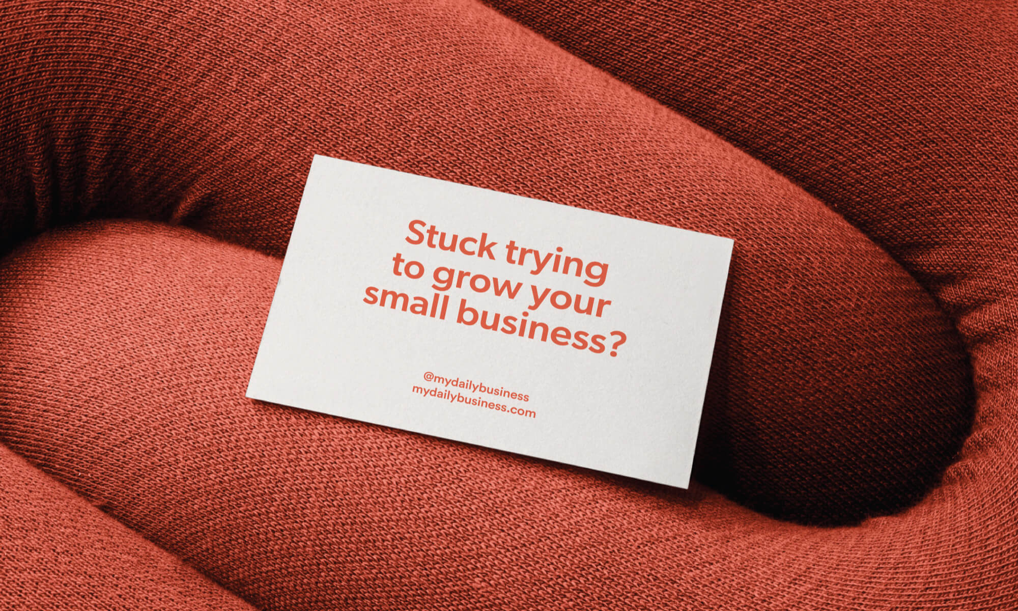 my daily business business card on red cusion